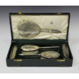 An Art Deco silver five-piece dressing table set, comprising hand mirror, two hairbrushes and two