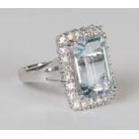 An 18ct white gold, aquamarine and diamond cluster ring, claw set with a rectangular cut