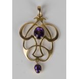 A gold and amethyst pendant in an Art Nouveau design, mounted with an oval amethyst above an oval