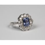 An 18ct white gold, sapphire and diamond ring, mounted with an emerald cut sapphire within a