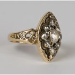 A gold and diamond ring in a pierced marquise shape, set with rose cut diamonds between pierced