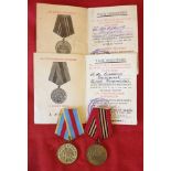 2 Russian WW2 medals with accompanying medal award cards.