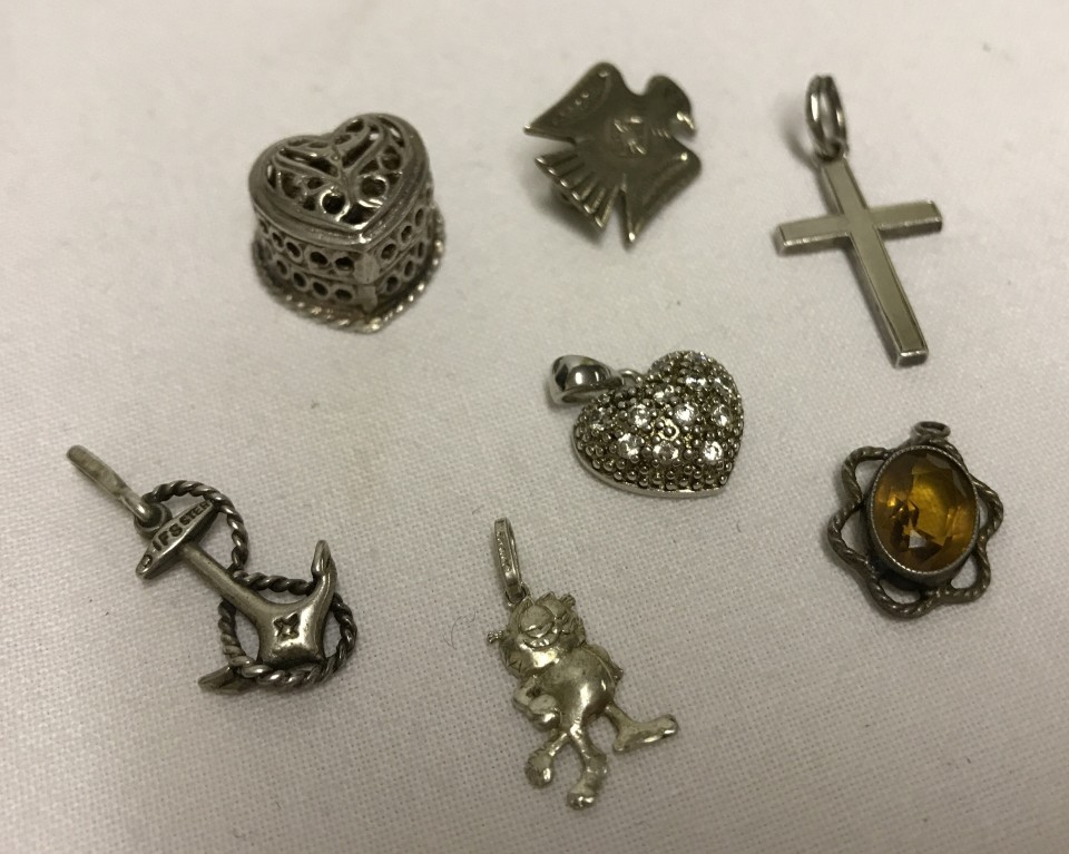 7 silver/white metal pendants / charms / brooch.