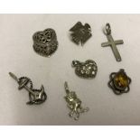 7 silver/white metal pendants / charms / brooch.
