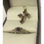 A gold dress ring set with a garnet, together with a gold cross set with garnets and a seed pearl.