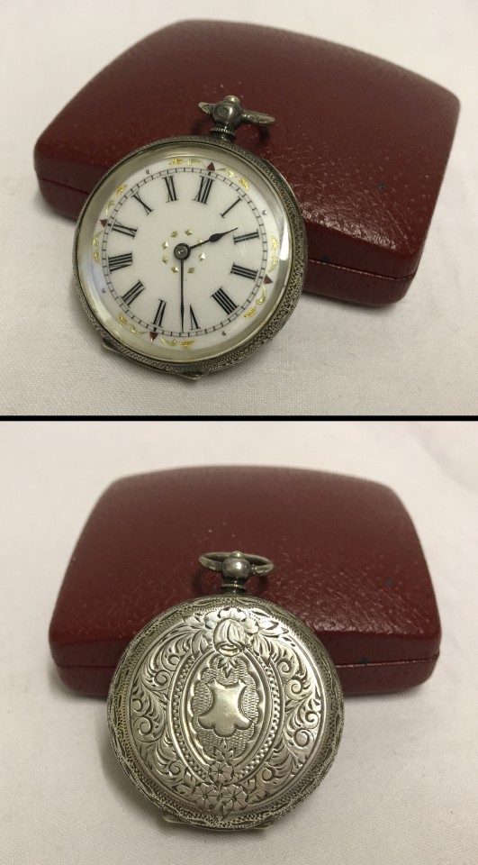 A ladies silver pocket watch with engraved detail to sides and back.