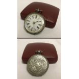 A ladies silver pocket watch with engraved detail to sides and back.