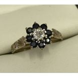 A 9ct gold illusion set diamond & sapphires cluster ring.