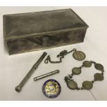 A heavy silver plated cigarette / trinket box containing assorted items.