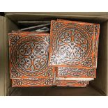 A box of retro orange and beige design wall tiles.