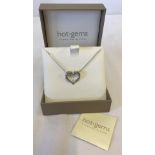 A boxed Hot Gems sterling silver heart shaped necklace set with small cz stone.