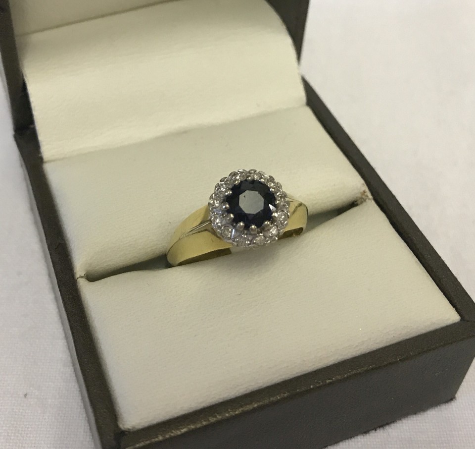 A hallmarked 18ct gold sapphire and diamond cluster ring.