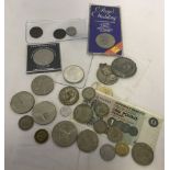 A tin of vintage coins, medals and bank notes.