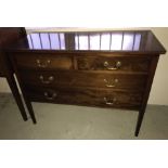 An antique mahogany 2 over 2 chest of drawers on tapered legs.