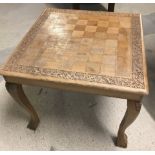 A vintage light wood coffee table with chess board top.