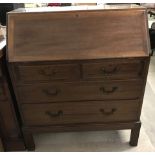 A vintage mahogany 4 drawer bureau with interior compartments and drop down handles.