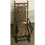 Spring framed rocking chair with turned decoration woodwork and tapestry seating.