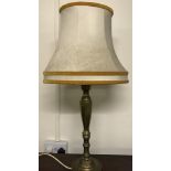 A vintage brass based table lamp with cream lamp shade.