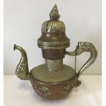 An oriental copper and brass kettle with dragon design handle.