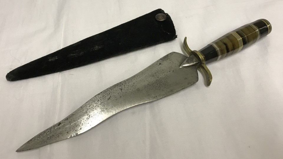 A serpentine bladed dagger with banded onyx and brass handle set with coin pommel.