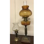 2 vintage brass oil lamps with glass shades.