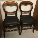 A pair of balloon back bedroom chairs with turned legs and leatherette seats.