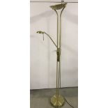 A modern brushed brass effect standard lamp with adjustable reading light.