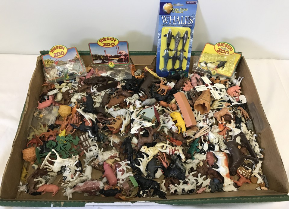 A box of plastic farm and zoo animals.