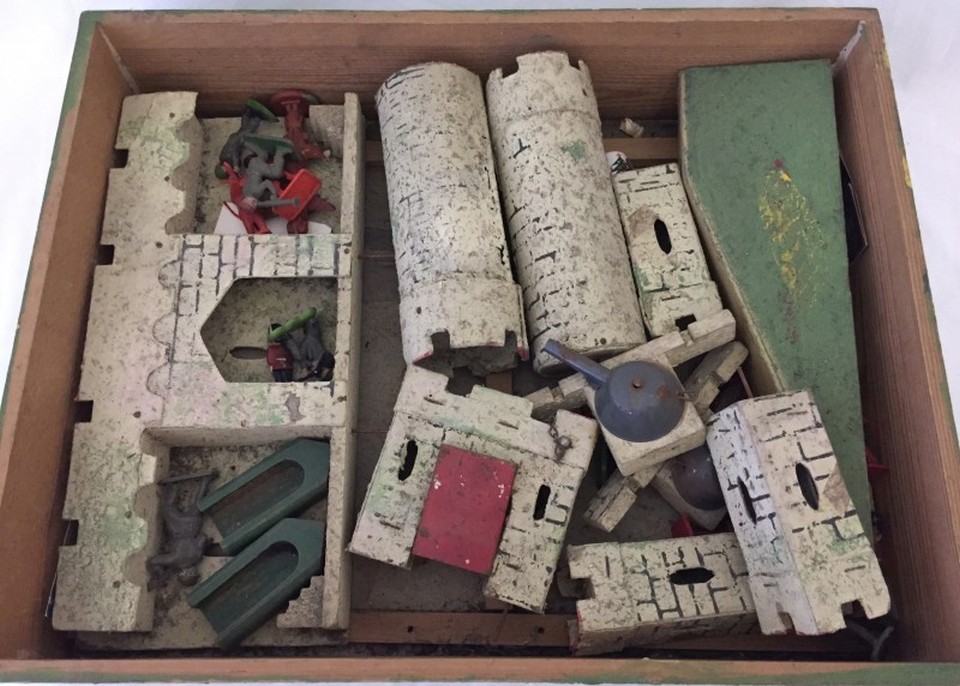 A c.1920/30's wooden toy soldier castle and assorted plastic soldiers.