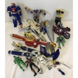A collection of action figures, weapons and vehicles.