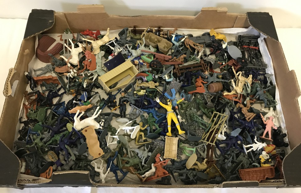 A box of plastic toy soldiers , cowboys, Indians and sci fi figures.