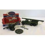 A boxed Crescent #1250 25 Pounder Light Artillery Gun with an unboxed Dinky military vehicle.