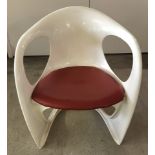 A vintage cream plastic S frame chair with red vinyl removable seat.