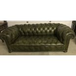A vintage green leather 2/3 seater chesterfield settee.