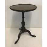 A Victorian mahogany tripod wine table with turned decoration to pedestal.