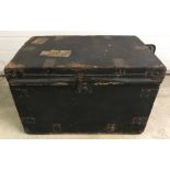 A vintage wooden 2 handled travelling chest with paper lining and metal banding.