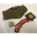 A bag of Queen's Surreys metal and cloth badges.