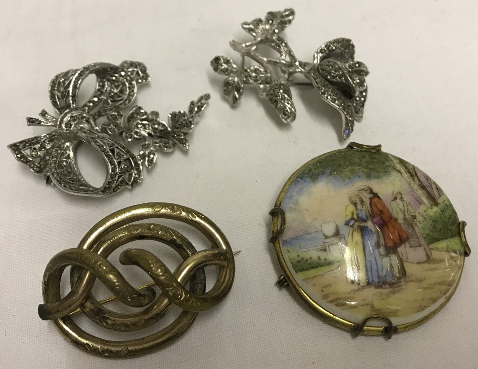 A collection of 4 vintage brooches.