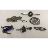 A collection of 6 silver and white metal brooches.