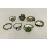 A collection of 7 ladies silver rings. Some stone set.
