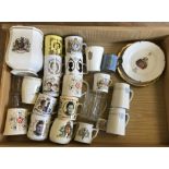 A box of assorted commemorative ceramics to include mugs, plates and jugs.