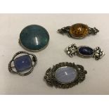 A collection of 5 silver and white metal brooches all set with natural stones.