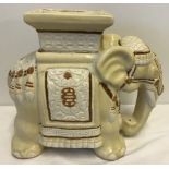 A ceramic elephant jardiniere stand in white, cream and brown.