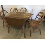 An Ercol oval drop leaf table and 4 chairs.
