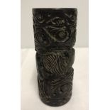 A carved wooden brush pot with lion and gazelle detail.