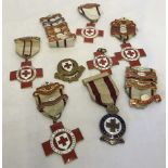 A collection of 7 vintage British Red Cross medal with year bars.