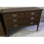 An antique mahogany 2 over 2 chest of drawers on tapered legs.