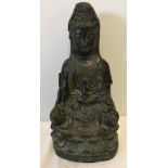 A 20th century hollow bronze seated Guan Yin figure.