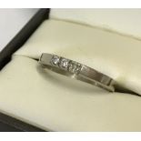 A 14k white gold dress ring, past present future 3 diamond design.