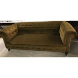 A vintage brown velvet upholstered chesterfield settee.